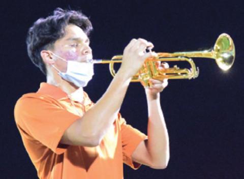 CALDWELL HIGH SCHOOL drum major Adolfo Gaucin plays a trumpet solo during the Caldwell-Academy halftime show on Friday.