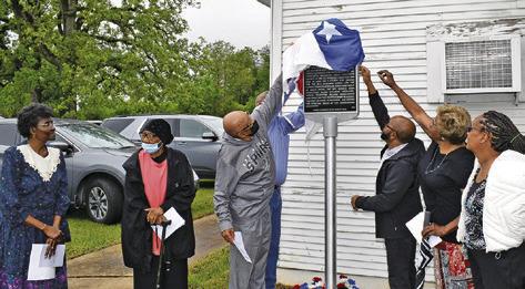 CHURCH MEMBERS UNVEIL this Texas Historical Marker at St. Matthew Missionary Baptist Church on Saturday, April 5. They include Wilma Hanks, Hazel Bryant, Melvin Morris, Caster Washington, Hubert Morris Jr., Ruthie Pollard Ellison and Grace Wilson. Tribune photo by Roy Sanders