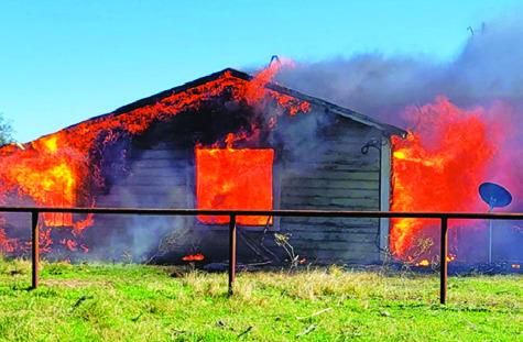 THE FIRE BURNS at this unoccupied house on County Road 244. Photo courtesy of Snook VFD