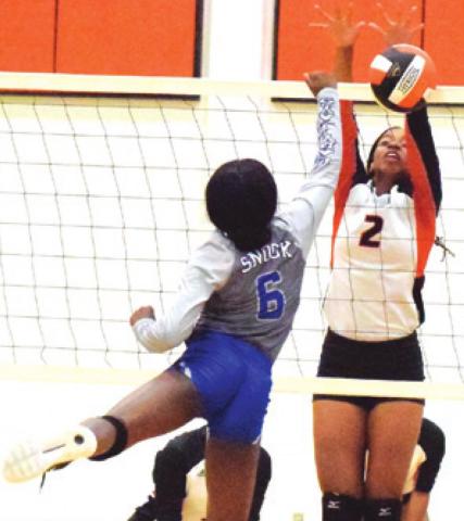 SOMERVILLE’S RA’MAYA CARTER blocks the hit by Snook’s Breanna Louis during the Lady Yeguas win over the Lady Jays last week.