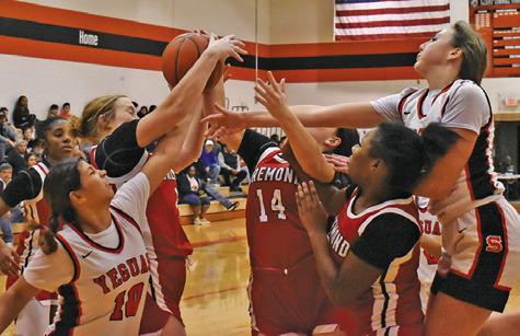 LADY YEGUAS CAPRI ALEJANDRO and Abigail Richardson fight with several Bremond players for a rebound during the Somerville-Bremond game last Friday night in Somerville. Tribune photo by Roy Sanders