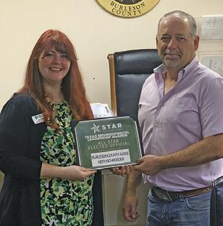 BURLESON COUNTY Judge Keith Schroeder is presented the TELA All-Star Elected Official Award by Zoe Killian, Keep Texas Recycling program manager at Keep Texas Beautiful.