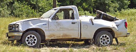 EMERGENCY RESPONDERS work the scene of this truck rollover accident on F.M. 908. Tribune photo by Kim Hutcheson