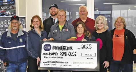DAVID PEVEHOUSE IS presented this check for $500 from Daniel/ Stark Law Firm in their Being Remarkable program