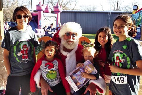 SANTA VISITS WITH CHILDREN at last year’s Santaville event in Somerville. Photo courtesy of Allyson Hargrove