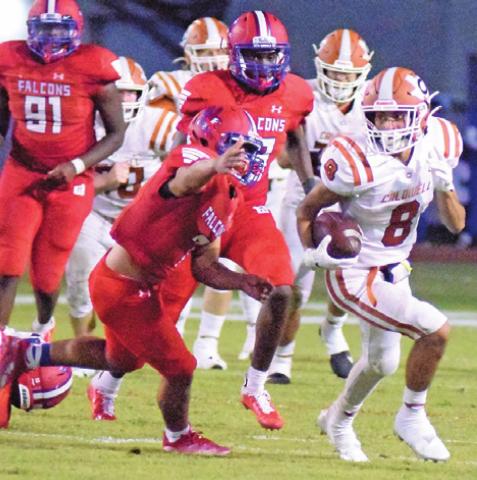 CALDWELL’S ZACH HEATON is being chased by a flock of Falcons, led by Erick Licona, after Heaton caught a pass from Ryan Shupak during last Friday night’s game. -- Tribune photo by Denise Squier