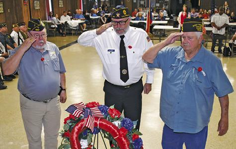 THE MEMORIAL DAY wreath is saluted at the Monday ceremony. Pictured from left are John Mayson of the DAV post, Lee Hoermann, representing the American Legion, and Donny Wood with the VFW.