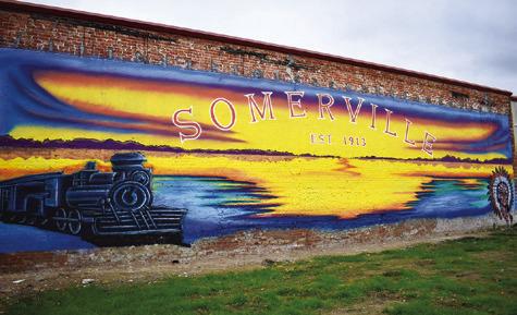 THIS MURAL IS ENJOYED by passersby in Somerville on the back wall of the fire department.