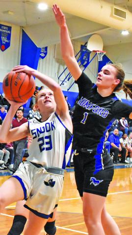 SNOOK’S DAKOTA Kienow attempts to shoot the ball while Mumford’s Allison Scamardodefends. -- Tribune photo by Roy Sanders