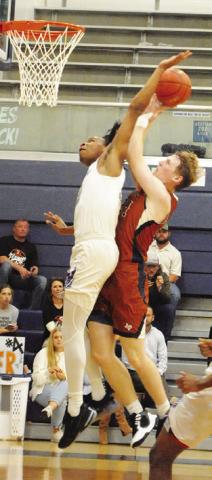 HARRISON NOVAK of Caldwell takes a shot as this Wheatley defender reaches to block it. -- Tribune photo by Denise Squier