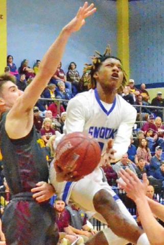 SIDNEY MACK OF Snook moves in for this shot despite some heavy pressure from the Thorndale defense. Mack was Snook’s leading scorer in the bi-district game. -- Tribune photo by Roy Sanders