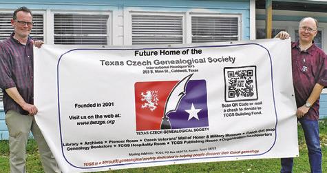 MICHAEL BRYANT AND Patrick Janis display this sign promoting the Texas Czech Genealogical Society’s new home in Caldwell.