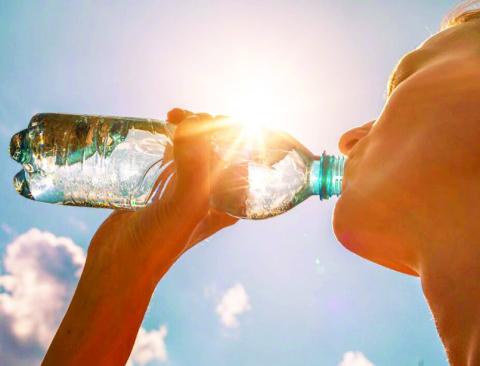 KEEPING WELL HYDRATED is one way to help avoid heat-related illnesses such as heat exhaustion or heatstroke. Adobe stock image