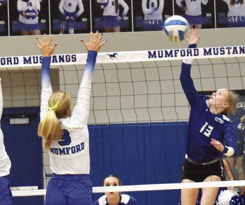 SNOOK’S DAKOTA KIENOW hits the ball past a Mumford blocker during the Lady Jays’ 9-25, 13-25, 17-25 loss to the Lady Mustangs. Tribune photo by Roy Sanders