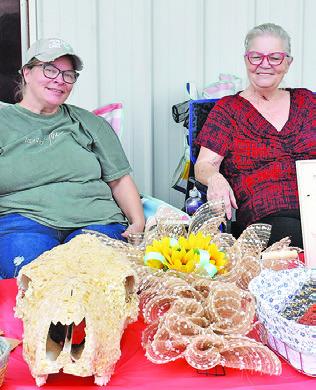 CANDICE KAZMIR AND Johnnie Oyler display these crafts at the Caldwell VFW Auxiliary craft and yard sale on Saturday, May 4.