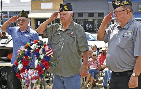 THE MEMORIAL DAY Wreath is placed on Monday at Memorial Day. Pictured from left are Henry Probst, Donny Wood and John Mayson.