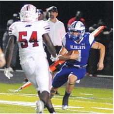 GARRETT HYVL returns this kickoff for a touchdown. -- Tribune photo by Denise Squier