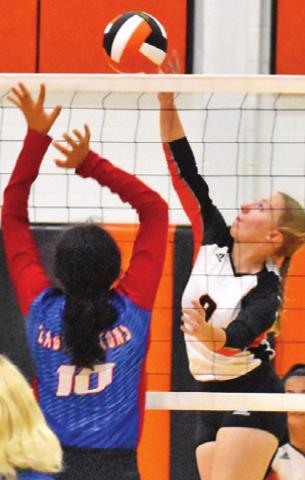 ABIGAIL FLENCHER hits the ball over Royal’s Stephanie De La Rosa during Somerville’s win Friday. -- Tribune photo by Roy Sanders