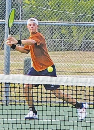 CALDWELL’S WAYLON Chapman sets to hit the ball during a tennis match in Bastrop.