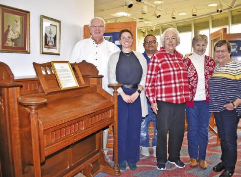 JOE RYCHLIK AND Caldwell Museum board members stand next to the organ. They include Kate Borroni, Donna Rychlik, LouAnn Englemann and Linda Chamberlain. Joining them was Chad Rogers, civic/visitors center coordinator. -- Tribune photo by Roy Sanders