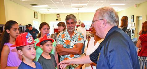 CALDWELL FIRE CHIEF Harry Bowers greets visitors on July 22 at the fire station during the 140th anniversary celebration. Tribune photo by Roy Sanders