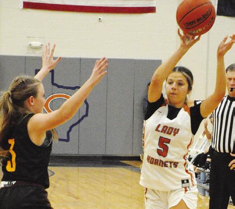 CALDWELL”S ASHLYN KELLUM passes the ball while Thorndale’s Jordyn Smith defends during the Lady Hornet-Lady Bulldog game last Friday night at Hornet Gym. -- Tribune photo by Denise Squier