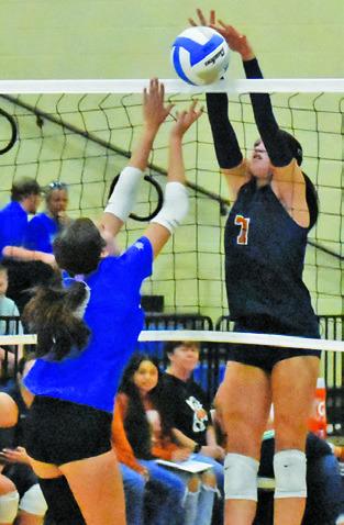 CLOEY RUSS goes up to block the ball during the Caldwell-Rockdale match last Friday. Tribune photo by Roy Sanders