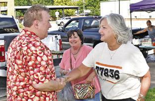 CALDWELL MAYOR JANICE Easter greets TV star Michael Marks, Your Produce Man, at the Farmers Market in downtown Caldwell.