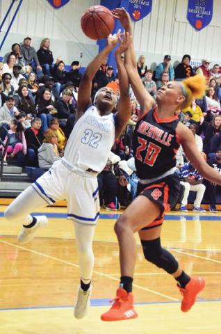 SOMERVILLE’S XADRIA MARTIN blocks a shot by Snook’s Jaivan Stringfellow during the Snook-Somerville district game last Tuesday night in Snook. -- Tribune photo by Denise Hornaday