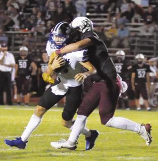 SNOOK QUARTERBACK BRETT Withem is tackled by a Tarkington defender. Tribune photo by Denise Squier