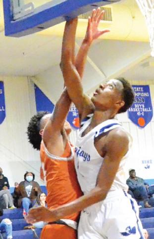 MA’DARIUS HAMILTON of Snook takes a shot as Caldwell’s Larry Davis tries to block it. -- Tribune photo by Roy Sanders