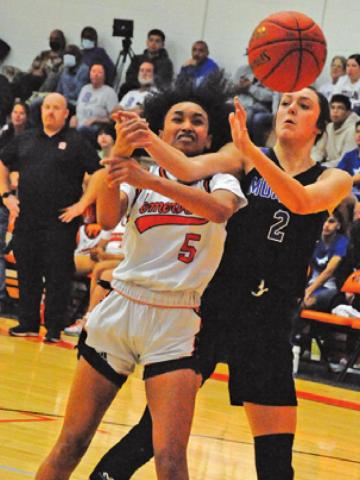 DESTINY VELA IS fouled while trying to drive down the lane to shoot the ball during the Somerville-Mumford game last week.
