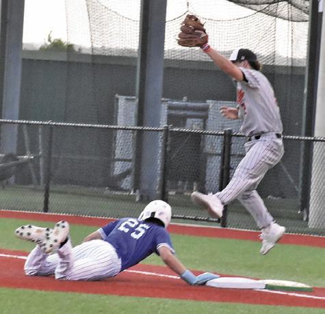 SOMERVILLE FIRST BASEMAN Colt Holton leaps high to catch the ball as this Mumford base runner gets back to first base. Tribune photo by Roy Sanders