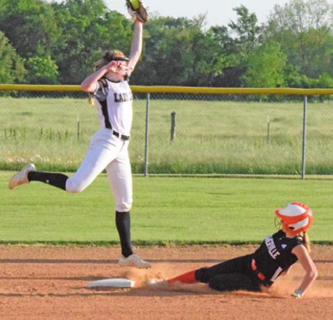 JAYCIE BRISCO LEAPS to catch the throw while Abigail Flencher slides safely into second base during the Snook-Somerville district game last Tuesday night in Snook. -- Tribune photo by Denise Squier