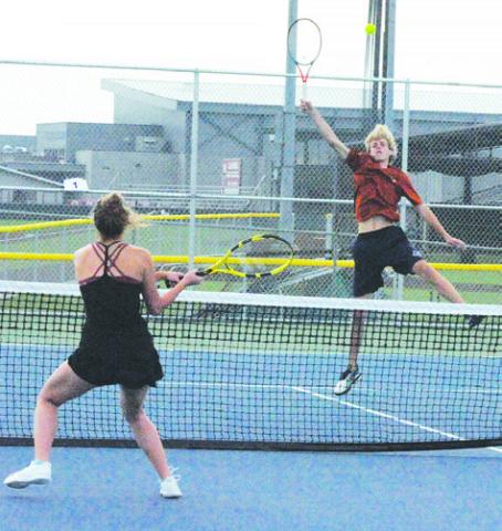 CALDWELL’S BREYDEN ATHEY volleys the ball during a mixed doubles match with partner Hope Savage last week. -- Tribune photo by Denise Squier