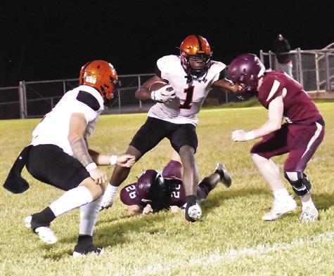 KEITH CRAWFORD CARRIES the ball against Milano. Also pictured is teammate Ian Teague. Somerville won 34-22. Tribune photo by Roy Sanders
