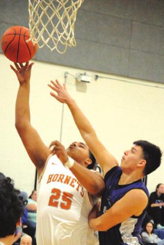 DEVLIN MORRIS REACHES for a rebound during the Caldwell-Florence game last Friday night. -- Tribune photo by Denise Squier