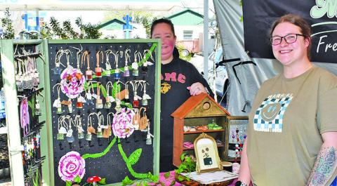 BRIANNA KELLER AND Rachael Schwab of Nanners Freshies &amp; Such work their booth on Sunday at the Somerville Farmers Market.