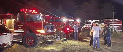 AREA FIREFIGHTERS RESPOND ON Monday at the grass fire off County Road 324 near the F.M. 696 intersection.