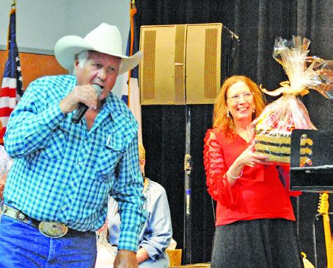 CHARLES DOONAN WAS THE auctioneer for the live auction at Saturday’s “Denim, Dinner &amp; Dancing Gala.” Also picture is Jodi Olive. Tribune photo by Denise Squier