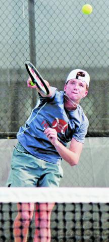 RYAN SEE SERVES to an Academy player during the Caldwell-Academy team tennis match last Monday in Caldwell.