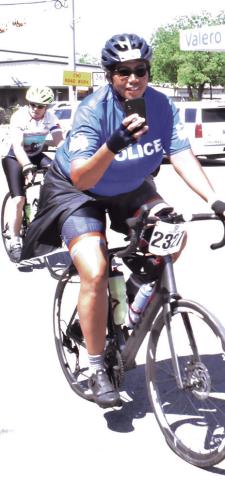 A BIKER ENJOYS the MS 150 bike ride on Sunday morning as it heads through Somerville. -- Tribune photo by Roy Sanders