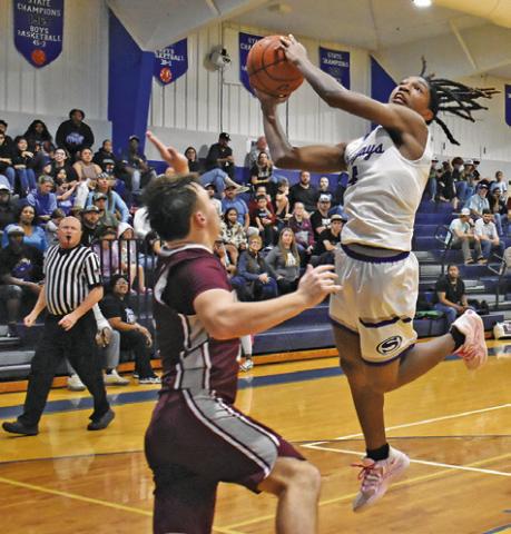 JOHN CARR LUNGES for this shot against Iola in Snook’s win. Tribune photo by Roy Sanders