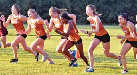 THE CALDWELL GIRLS CROSS country team leaves the starting line to run Saturday at the Caldwell Invitational XC Meet at Davidson Creek Park. The girls won the team title.