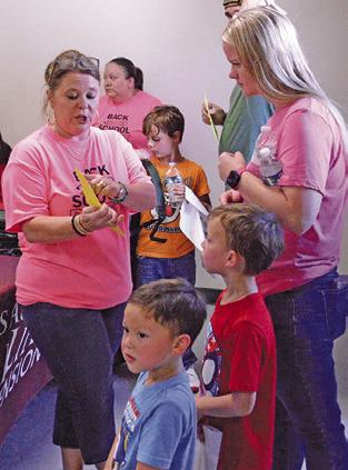 AGRILIFE EXTENSION Agent Holly Narro gives parents instructions at last week’s “Back-to-School Bash.” Tribune photo by Kimberly Hutcheson