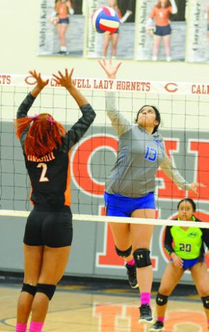 SNOOK’S KARLA LARA REACHES to get the ball past Somerville’s Ra’Maya Carter during the teams’ playoff match in Caldwell.