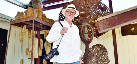 GRIFF SMITH STANDS next to his father Dr. Joe Smith’s sculptures at his home in Caldwell. Photography is his long-time passion. Tribune photo by Roy Sanders