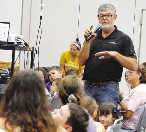LOCAL BEEKEEPER, PATRICK Schilling, spoke to area children about the world of beekeeping, bees, wasps and more during last Thursday’s “The Un-bee-lievable life of bees” event hosted by the Harrie P. Woodson Memorial Library. Tribune photo by Denise Squier