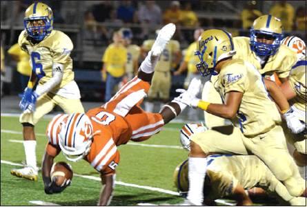 CALDWELL’S NICOLAS JOHNSON dives with the ball for extra yardage during Friday night’s Caldwell-Rockdale football game at Rockdale High School. The Tigers pulled out a 44-36 win despite a good showing from the Hornets. -- Tribune photo by Denise Hornaday