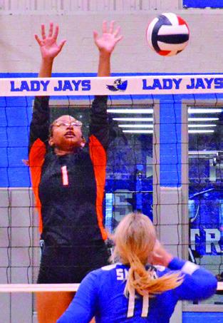 SOMERVILLE’S ALAZIA Vela reaches to attempt a block during the Lady Yeguas’ loss to Snook Friday. Also pictured is Aubrey Becker.